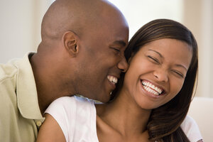 African American couple laughing together Austin, TX dental crowns and bridges